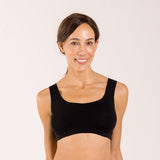 Woman wearing a black crop top bra made from seaweed to help alleviate the symptoms of menopause 