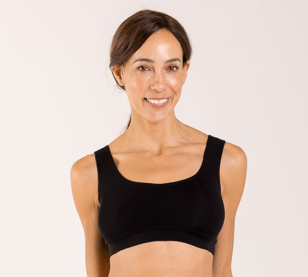 Woman wearing a black crop top bra made from seaweed to help alleviate the symptoms of menopause 