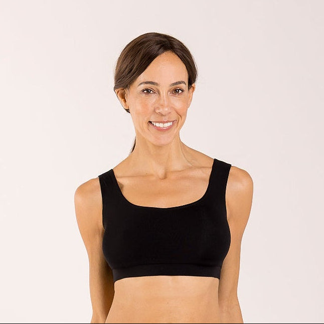 Woman wearing a black crop top bra made from seaweed to help alleviate the symptoms of menopause 