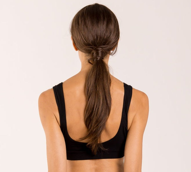 Woman wearing a crop top bra made from seaweed for menopause