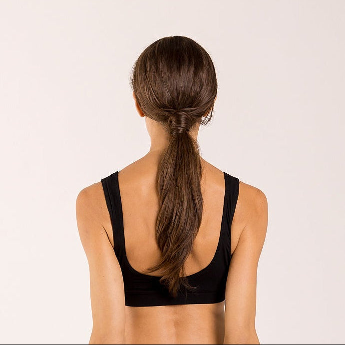 Woman wearing a crop top bra made from seaweed for menopause