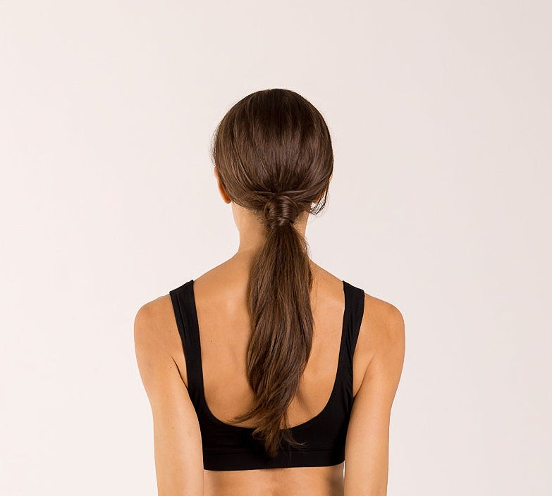 Woman wearing a crop top bra made from seaweed for menopause