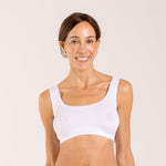 Woman wearing a white crop top bra made from seaweed and designed for menopause 