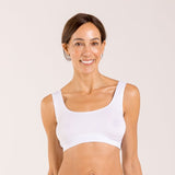 Woman wearing a white crop top bra made from seaweed and designed for menopause 