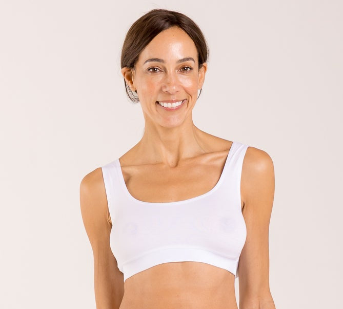 Woman wearing a white crop top bra made from seaweed and designed for menopause 