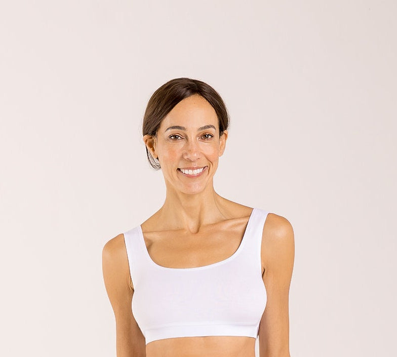 Woman wearing a white crop top bra made from seaweed and designed for menopause 
