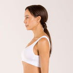 Woman wearing a white crop top bra made from seaweed to help alleviate the symptoms of menopause