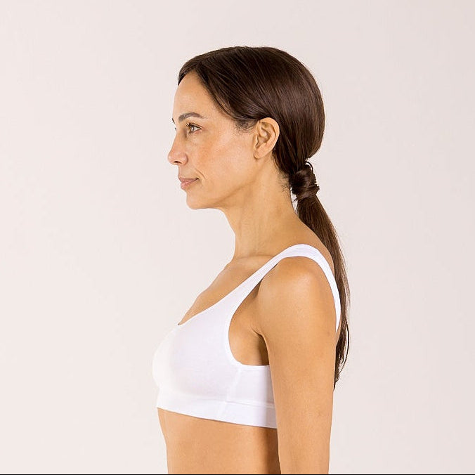 Woman wearing a white crop top bra made from seaweed to help alleviate the symptoms of menopause