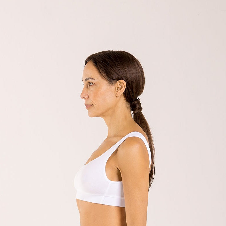 Woman wearing a white crop top bra made from seaweed to help alleviate the symptoms of menopause