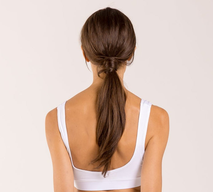 Woman wearing a white crop top made from seaweed to help alleviate the symptoms of menopause. 