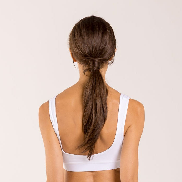 Woman wearing a white crop top made from seaweed to help alleviate the symptoms of menopause. 