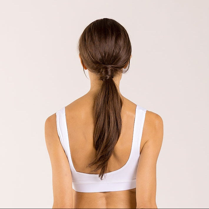 Woman wearing a white crop top made from seaweed to help alleviate the symptoms of menopause. 