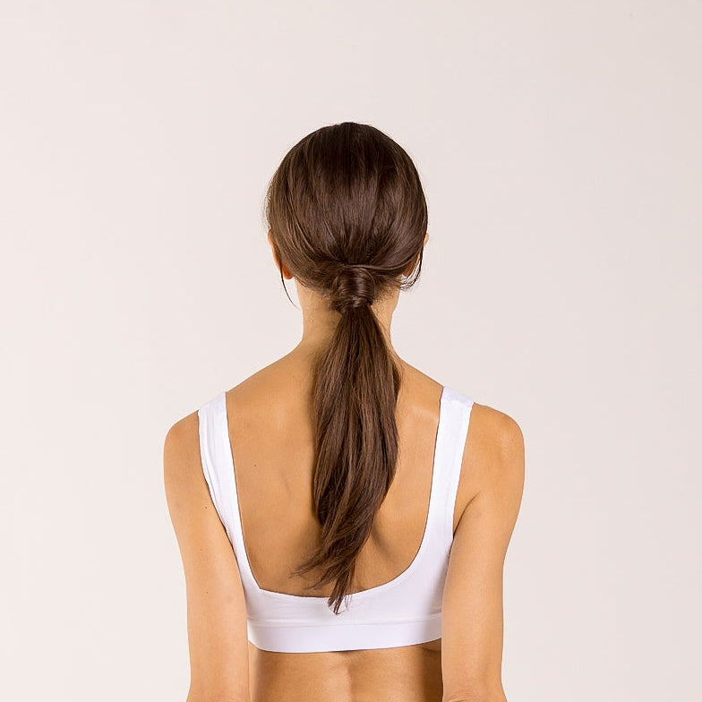 Woman wearing a white crop top made from seaweed to help alleviate the symptoms of menopause. 